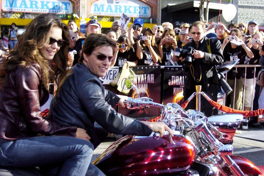 Our man Tom, with Katie Holmes in tow. Ah, Tom, why don't you ever wear a helmet on a bike? Photo: Everett Collection/Shutterstock.com