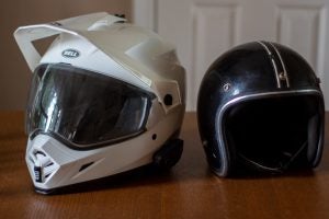 A new Bell MX-9 Adventure helmet with MIPS tech, Cardo comms, a photochromic visor and comfy interior. On the right, an old skid lid  from the 1970s.  Photo by Bill Roberson